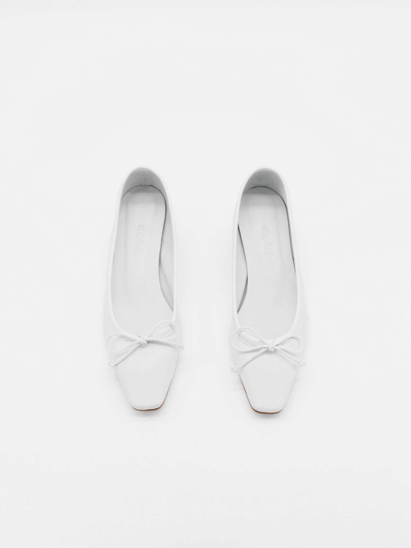 About Arianne Mina White Flats
