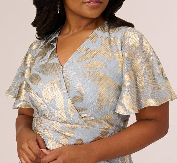 Adrianna Papell Plus Size Foil Leaf Short Sleeve Gown With Draped Details In Light Blue Gold