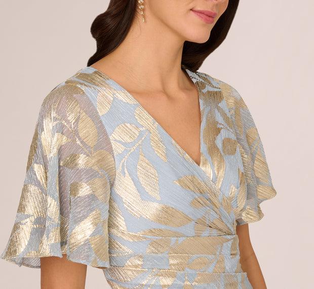 Aidan Mattox Foil Leaf Short Sleeve Gown With Draped Details In Light Blue Gold