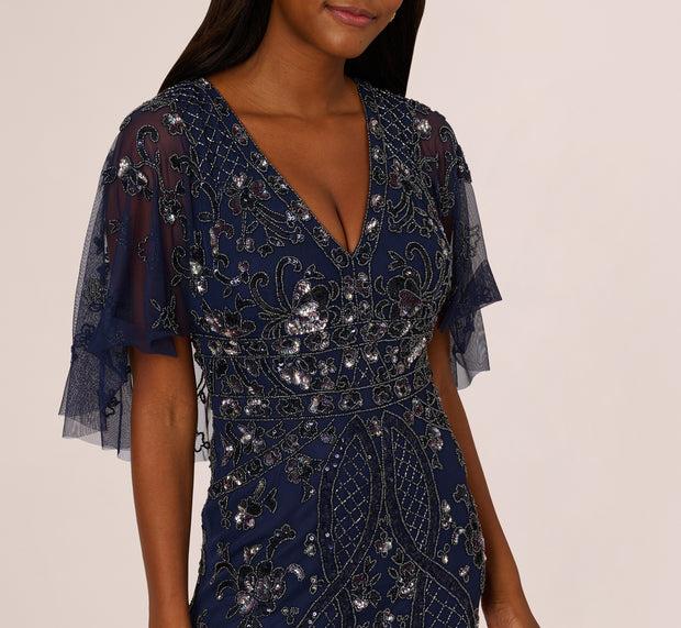 Aidan Mattox Sequin Beaded Gown With Sheer Cape Sleeves In Light Navy