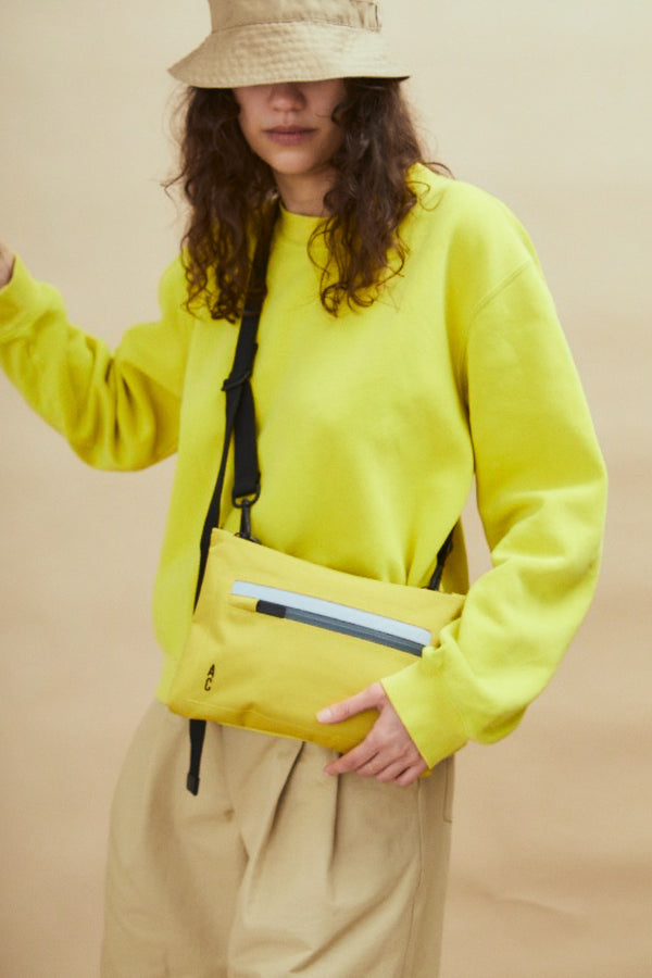 Ally Capellino Herb Travel Cycle Crossbody Bag In Lemon