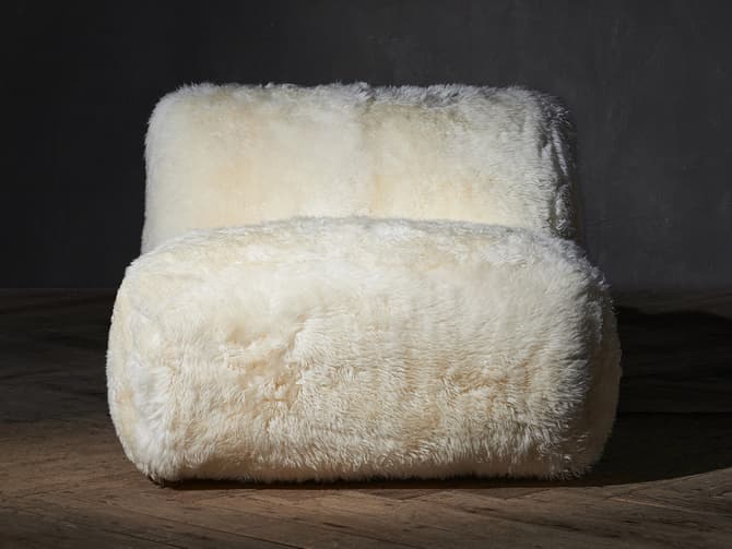 andrew martin Luxurious sheepskin motion chair by Timothy Oulton