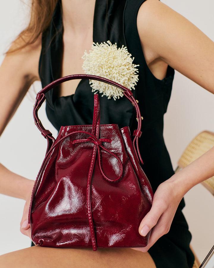 Anonymous Copenhagen Kacey Petite Bucket Bag Crinkled Polished Goat Pomegranate