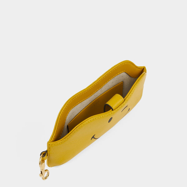 Anya Hindmarch Wink Sunglasses Holder Capra Leather In Mustard Yellow