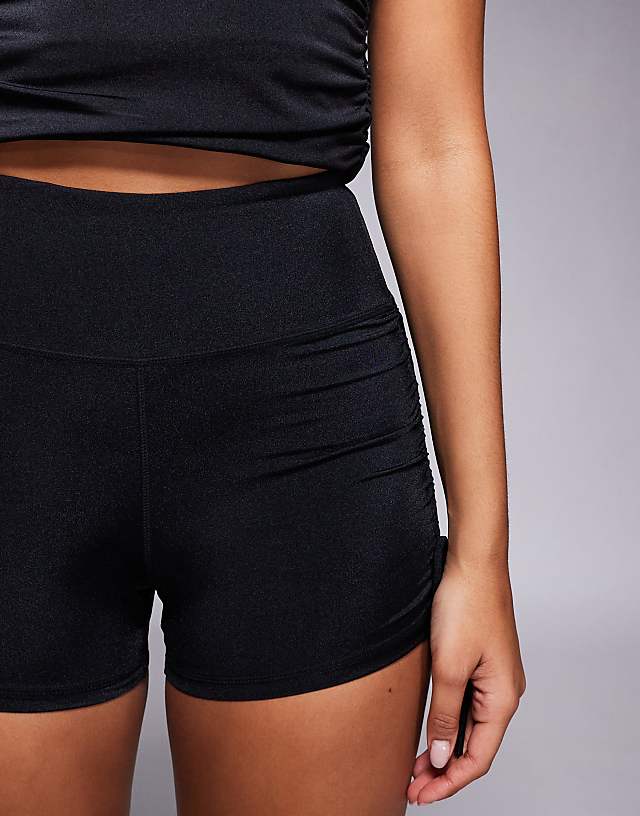 Asos 4505 Hourglass Ruched Side Tie Booty Shorts In Black High Shine