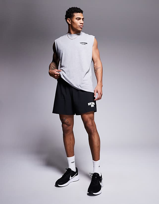 asos 4505 loose fit quick dry graphic training shorts with zip pockets in black