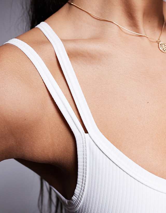 Asos 4505 Soft Touch Rib Light Support Sports Bra With Adjustable Straps In White