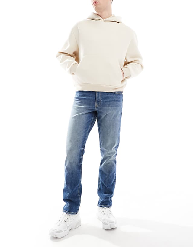 asos ASOS DESIGN slim jeans in mid wash blue