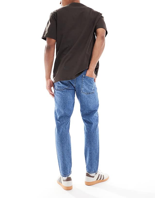 Asos ASOS DESIGN Tapered Jean In Mid Wash Blue