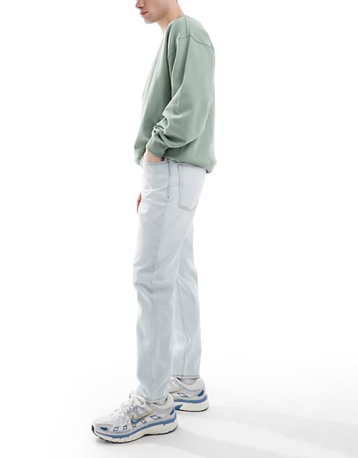 Asos ASOS DESIGN Tapered Jeans In Bleach Wash Blue