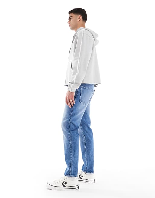 Asos ASOS DESIGN Tapered Jeans In Light Wash Blue