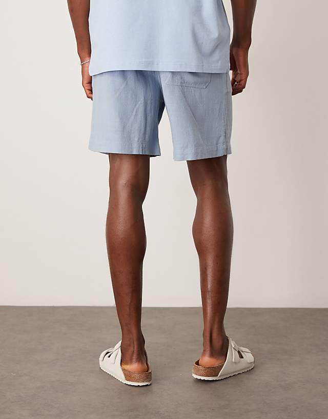 Asos ASOS DESIGN Baggy Pull On Shorts In Blue Linen Rich