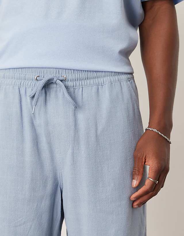 Asos ASOS DESIGN Baggy Pull On Shorts In Blue Linen Rich