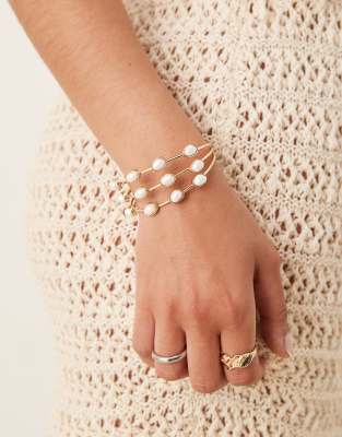 Asos ASOS DESIGN Cuff Bracelet With Triple Row Of Faux Pearls In Gold Tone