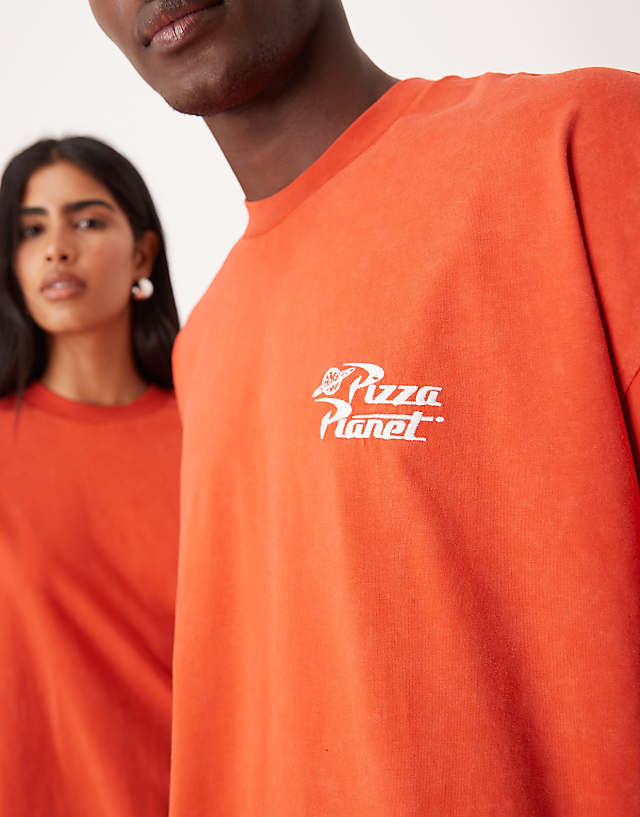 Asos ASOS DESIGN Disney Pixar Unisex Oversized T-shirt With Toy Story Pizza Planet Prints In Washed Red