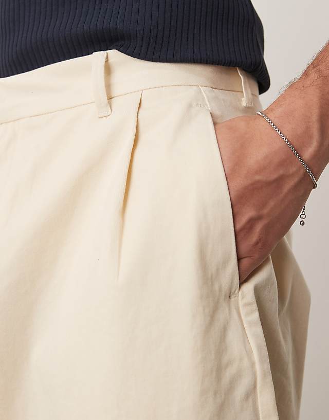 Asos ASOS DESIGN Extreme Tapered Trousers With Pleats In Beige