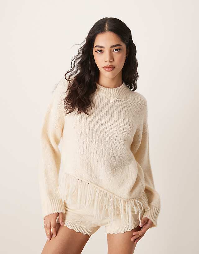 asos ASOS DESIGN knitted crew neck jumper with fringe hem detail in cream asos ASOS DESIGN knitted crew neck jumper with fringe hem detail in cream