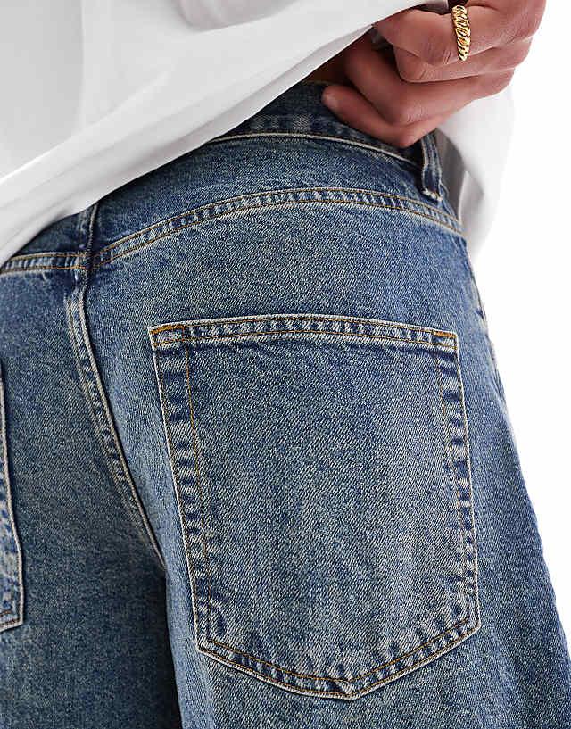 Asos ASOS DESIGN Long Length Denim Jort In Mid Wash Blue