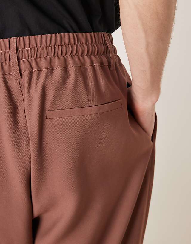 Asos ASOS DESIGN Loose Fit Smart Trousers With Wide Waistband And Elasticated Waist In Brown