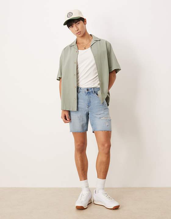 asos ASOS DESIGN mid length slim denim shorts with rips in light wash blue