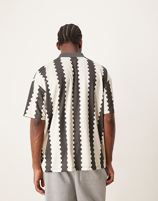 Asos ASOS DESIGN Oversized Polo With Sports Graphic And All Over Print