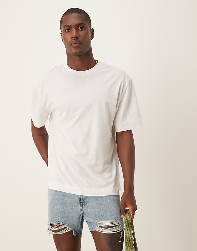 asos ASOS DESIGN shorter length straight fit denim shorts with rip detail in light wash blue