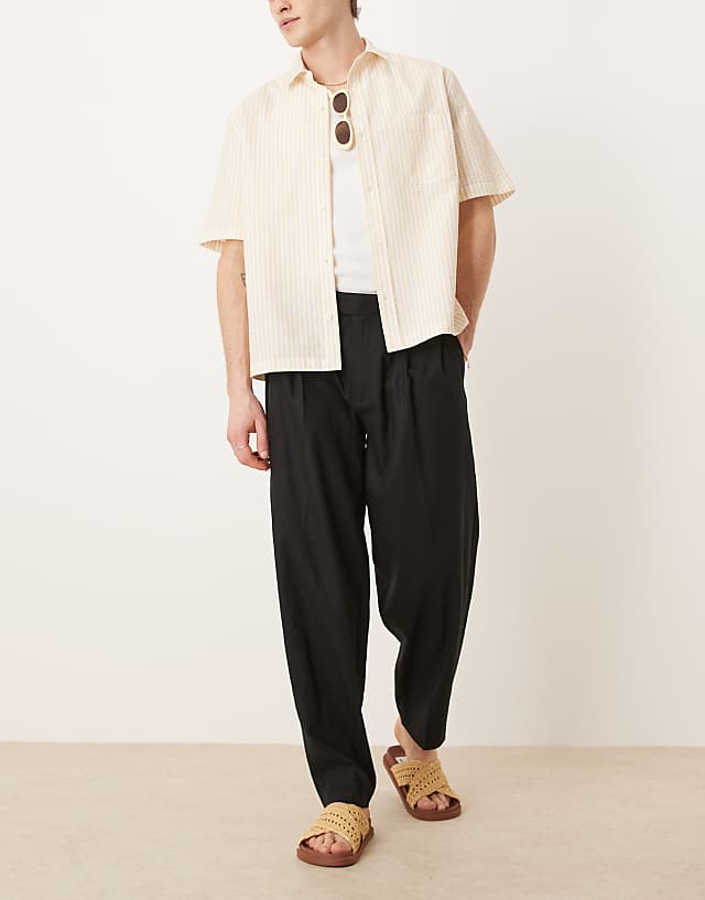 asos ASOS DESIGN smart oversized tapered linen blend trousers with front pleat in black
