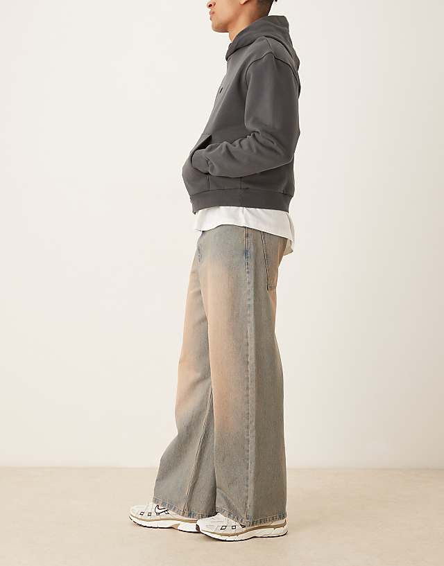 Asos ASOS DESIGN Super Baggy Jeans With Heavy Red Tint In Mid Wash Blue