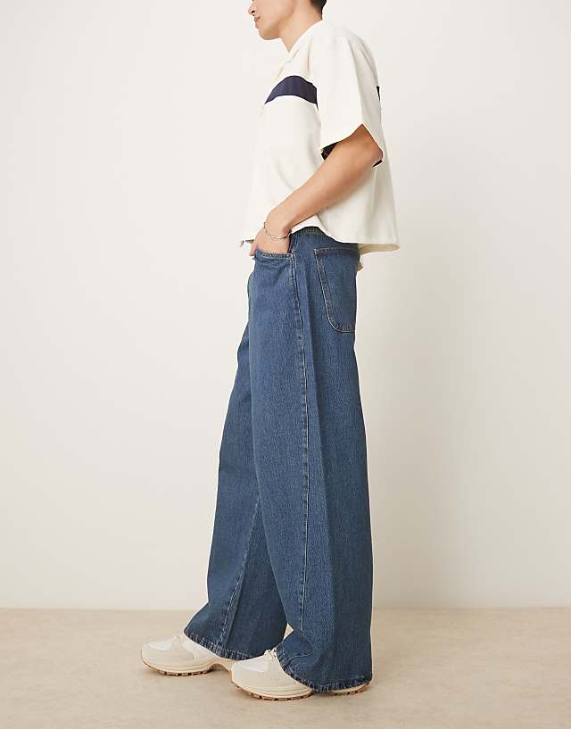 Asos ASOS DESIGN Super Baggy Jeans With Twisted Seams In Mid Wash Blue