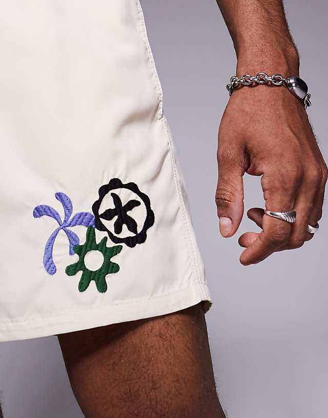 Asos ASOS DESIGN Swim Shorts In Short Length With Embroidery In Neutral