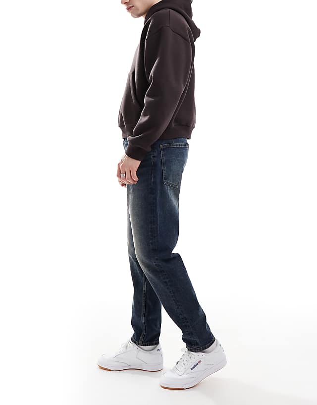 Asos ASOS DESIGN Tapered Jeans With Vintage Tint In Dark Wash Blue