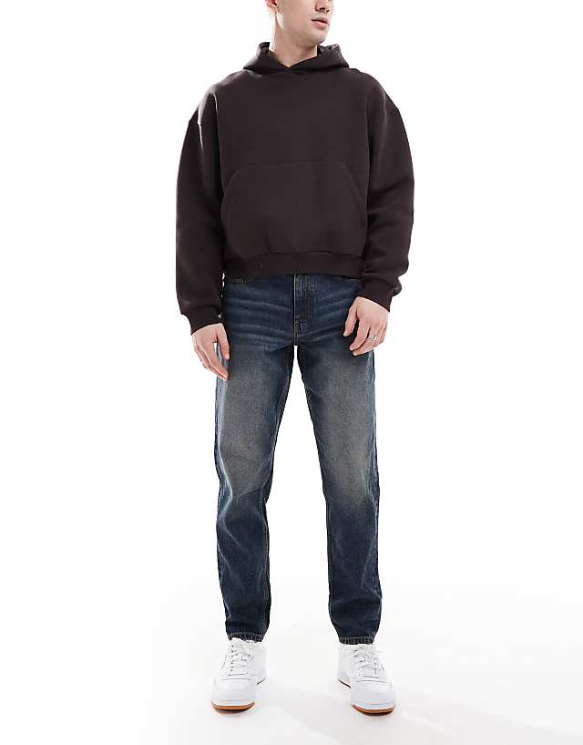 asos ASOS DESIGN tapered jeans with vintage tint in dark wash blue