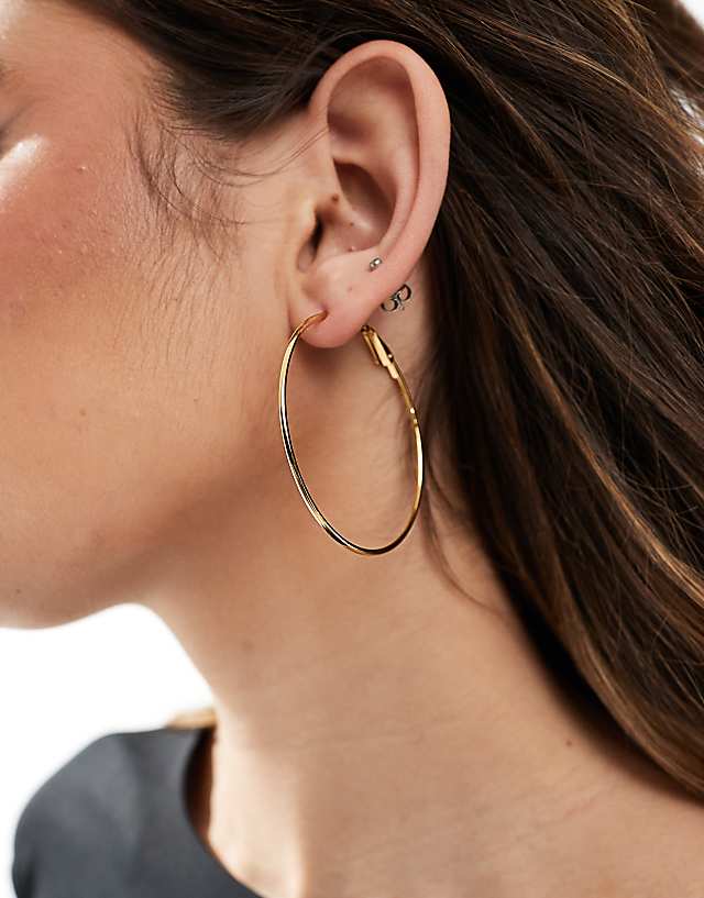 asos ASOS DESIGN waterproof stainless steel hoop earrings with skinny detail in gold tone