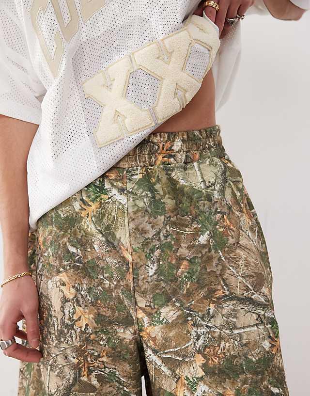 Asos COLLUSION Skater Relaxed Jersey Shorts In Tree Camo Print - MULTI