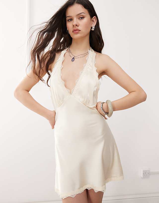 asos Lioness Stars Align satin lace trim halterneck plunge mini slip dress in cream