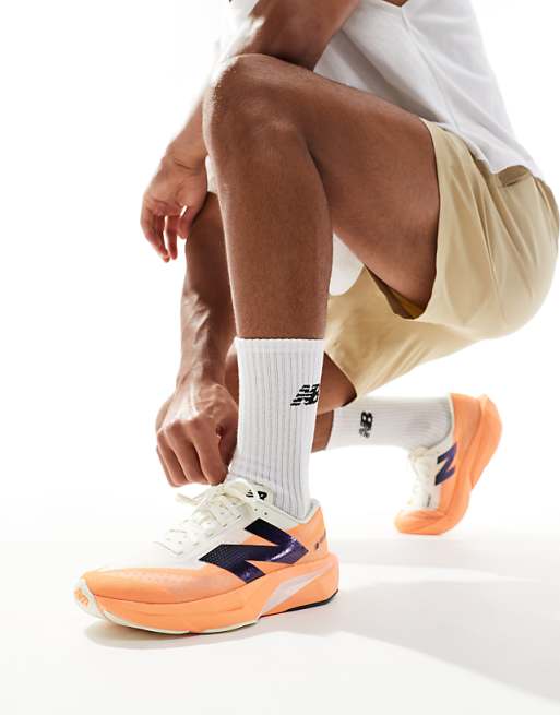 asos New Balance Fuelcell Rebel V4 running trainers in orange