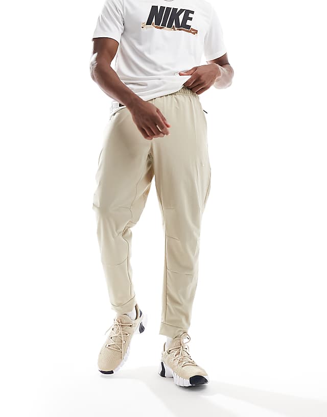 Asos Nike Training Unlimited Dri-FIT Track Trouser In Beige