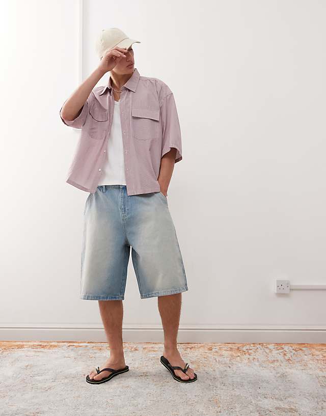 asos Reclaimed Vintage oversized longline denim jort in light blue faded wash