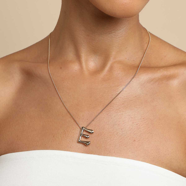 Astrid & Miyu E Initial Bold Pendant Necklace In Gold