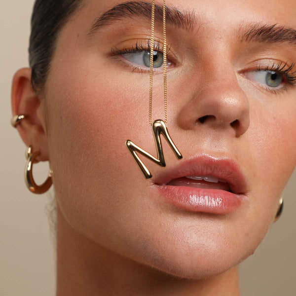 Astrid & Miyu M Initial Bold Pendant Necklace In Gold
