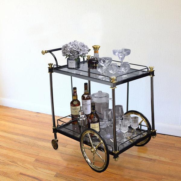 benzara BM194350 Metal Framed Serving Cart with Glass Shelves and Side Handle Black and Gold