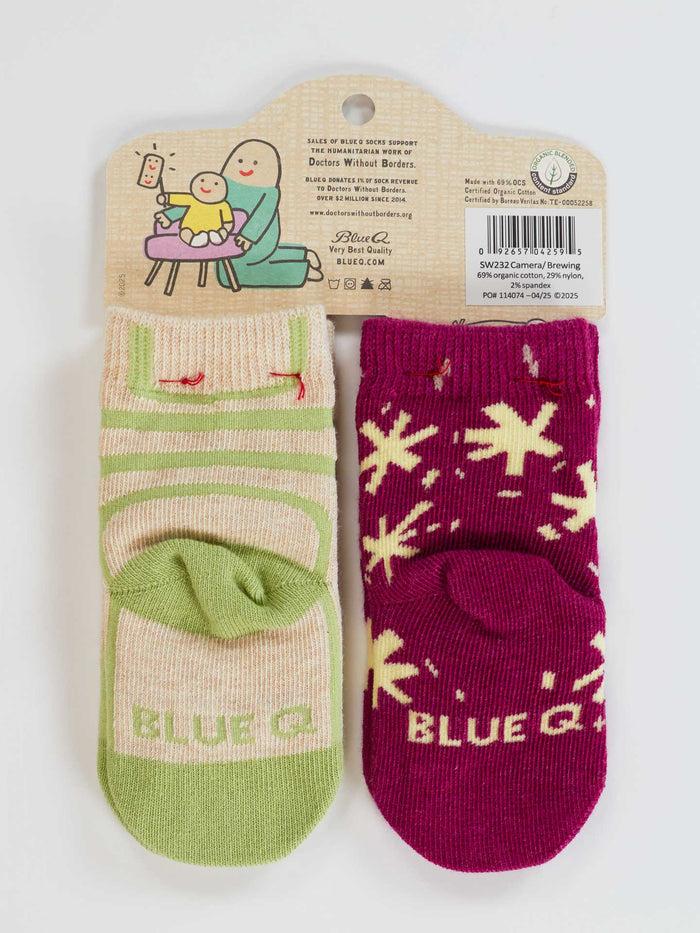 Blue Q The Camera Loves Me/ I Got One Brewing Baby Socks