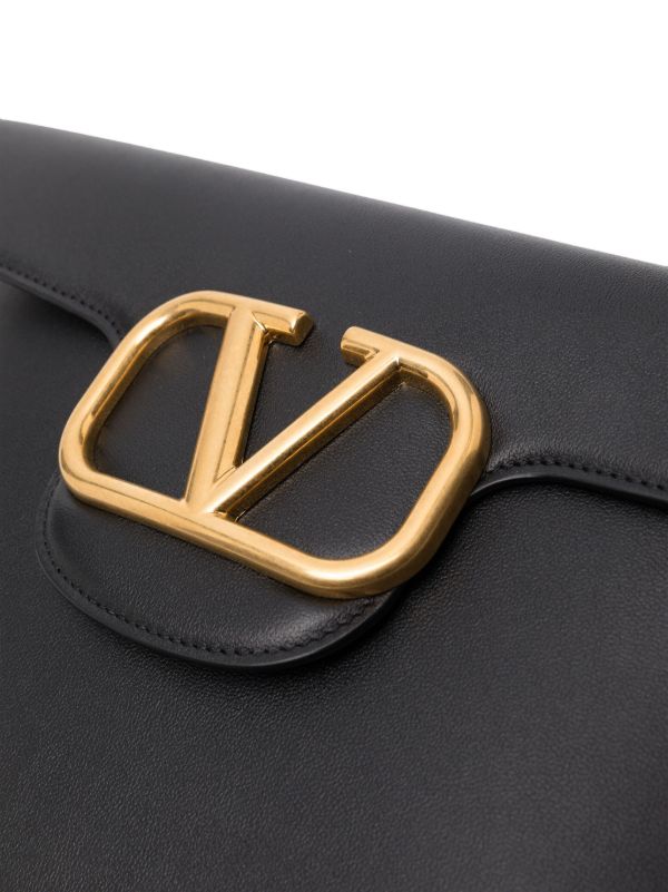 Browns Valentino Garavani Black Locò Leather Clutch Bag | Browns Clutch Bags