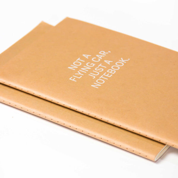 Charles And Marie NOT A FLYING CAR | Beiges Kraftpapier NOTIZBUCH | A5 Punktraster | Octàgon Design