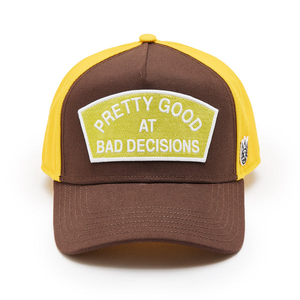 cult of individuality Cult's Logo Mesh Back Trucker Hat "Good At Bad Decisions" in Chocolate Hats cult of individuality Cult's Logo Mesh Back Trucker Hat "Good At Bad Decisions" in Chocolate Hats