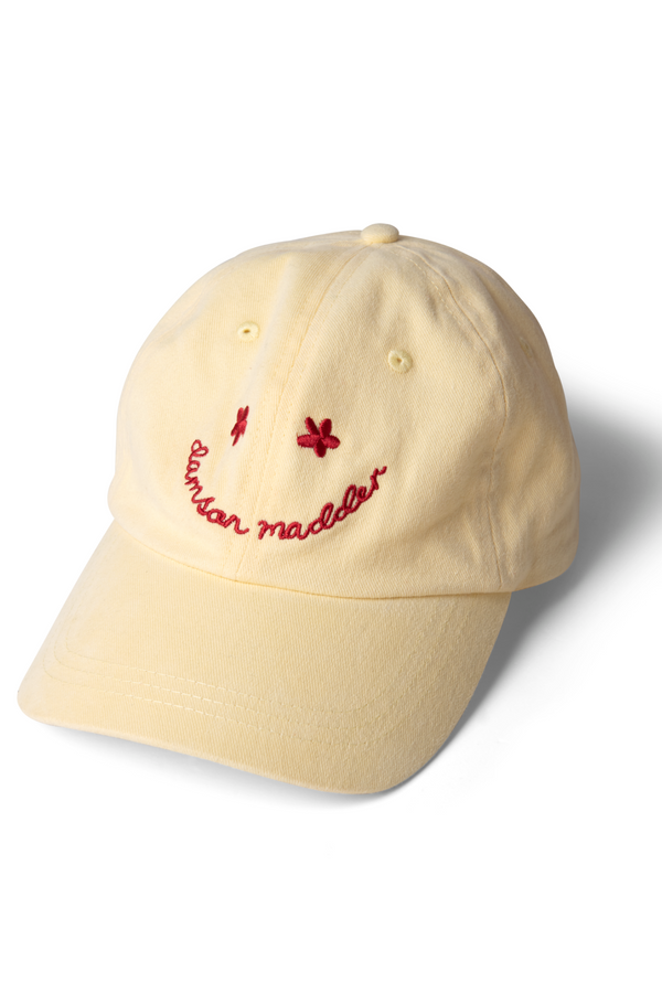 damson madder washed smiley cap in butter with red embroidery