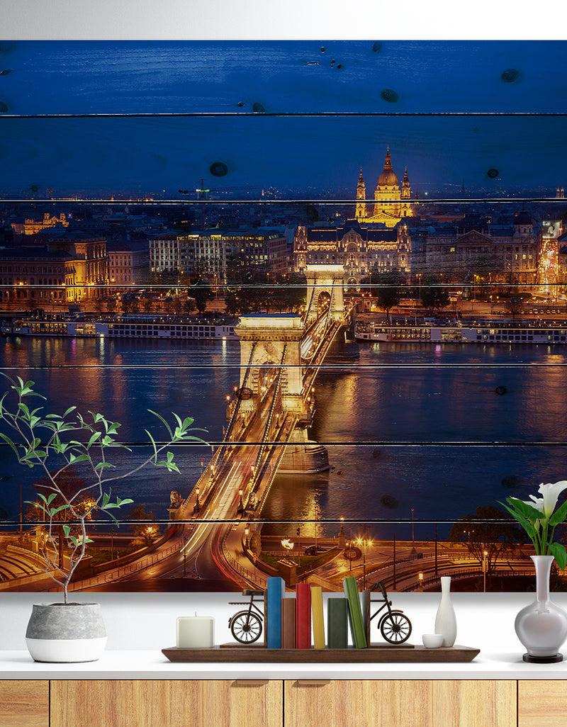designq Illuminated Cain Bridge Budapest - Cityscape Print on Natural Pine Wood