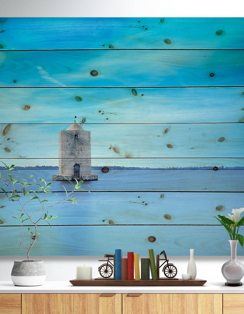 designq Old Spanish Windmill in Blue Lagoon - Seashore Print on Natural Pine Wood