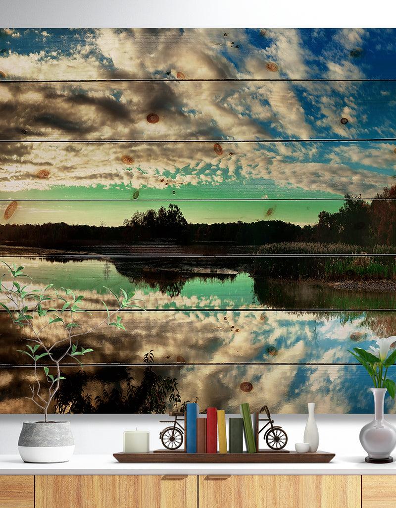 designq Sky Clouds Mirrored in River Panorama - Landscape Print on Natural Pine Wood