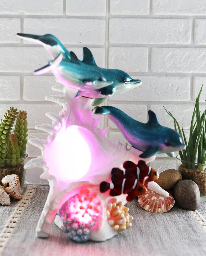 Ebros Gift Ebros Nautical Ocean Family 3 Dolphins Swimming Over Giant Sea Conch Clownfishes And Anemones Statue With Colorful LED Light 9.5" Tall
